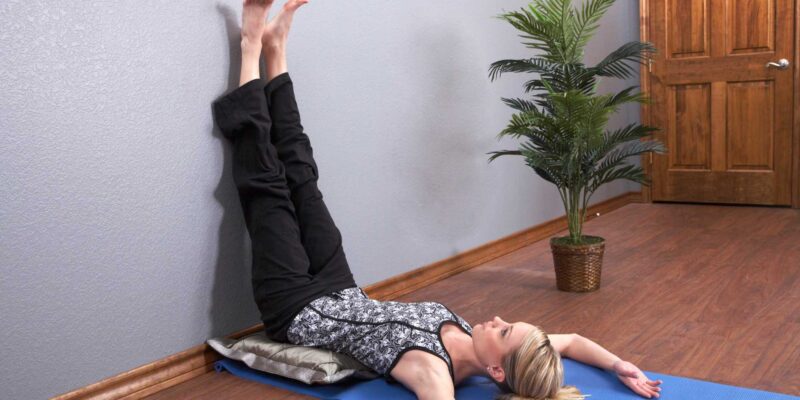 Women with legs up against the wall